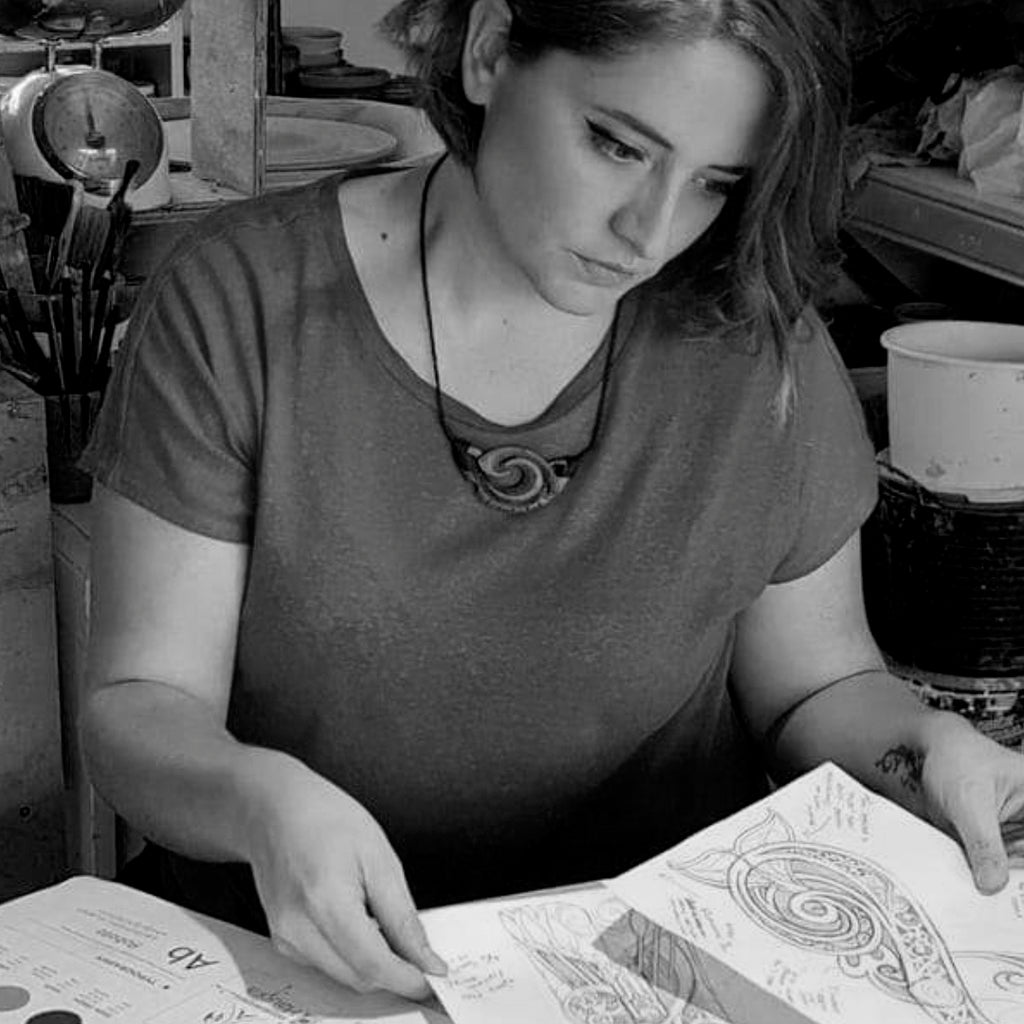 Person sitting at a table with a design project in a workshop setting