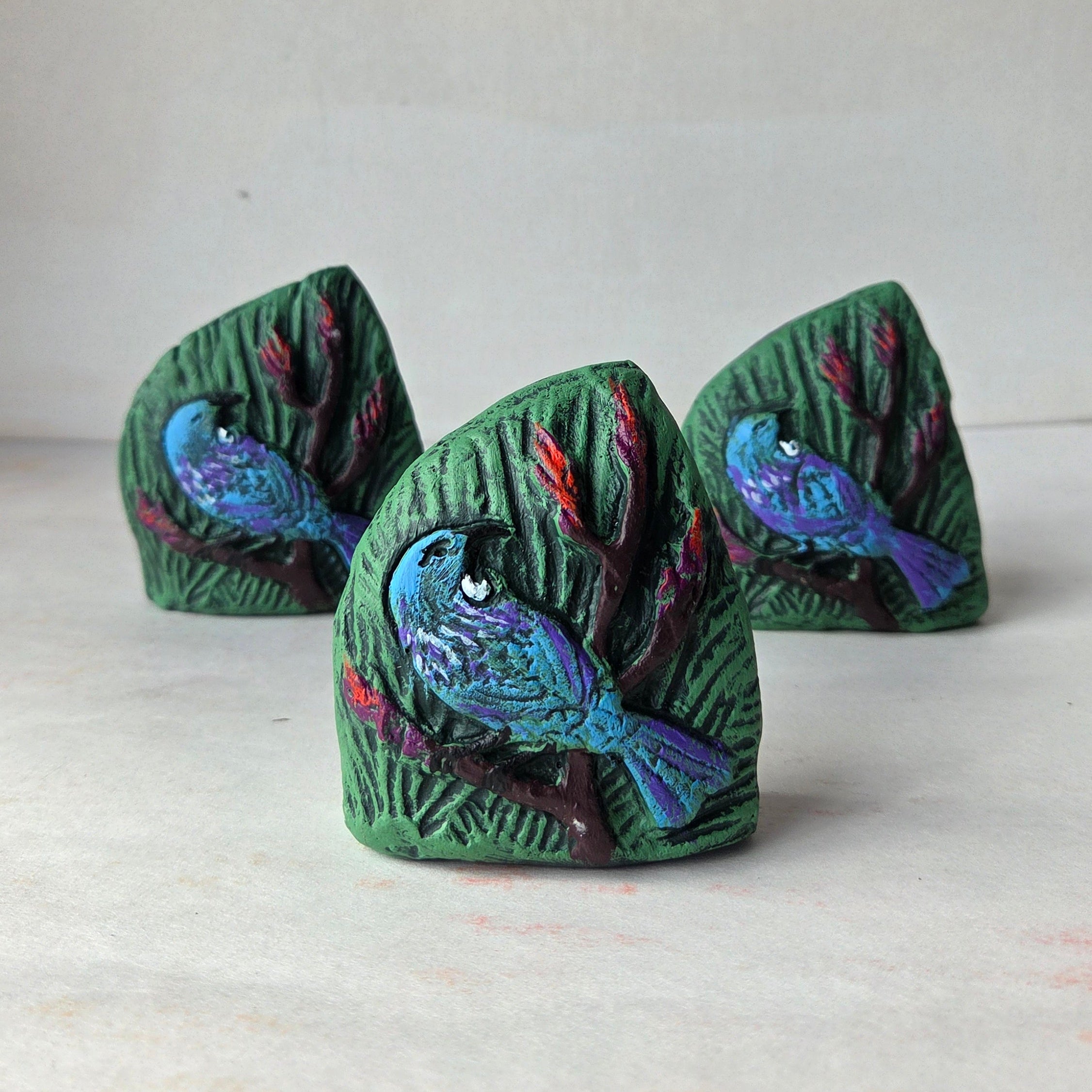 Decorative wall art with tui bird design on a plain background