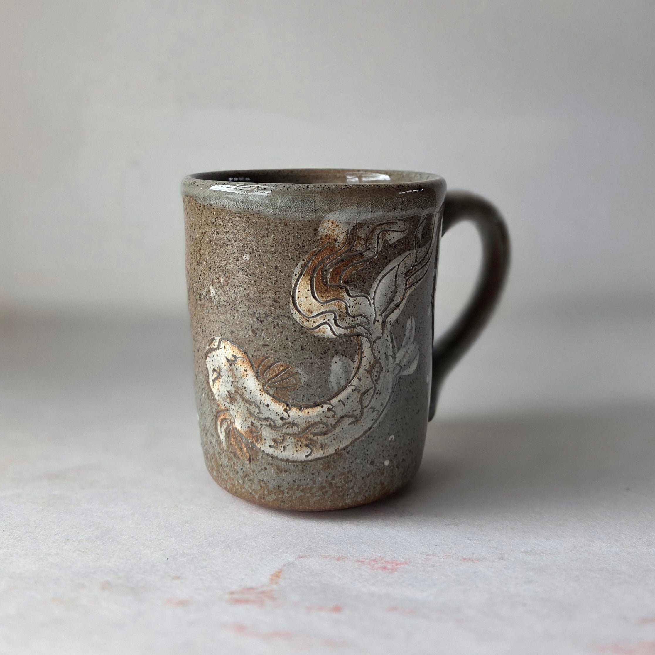 Ceramic mug with abstract design on a light background