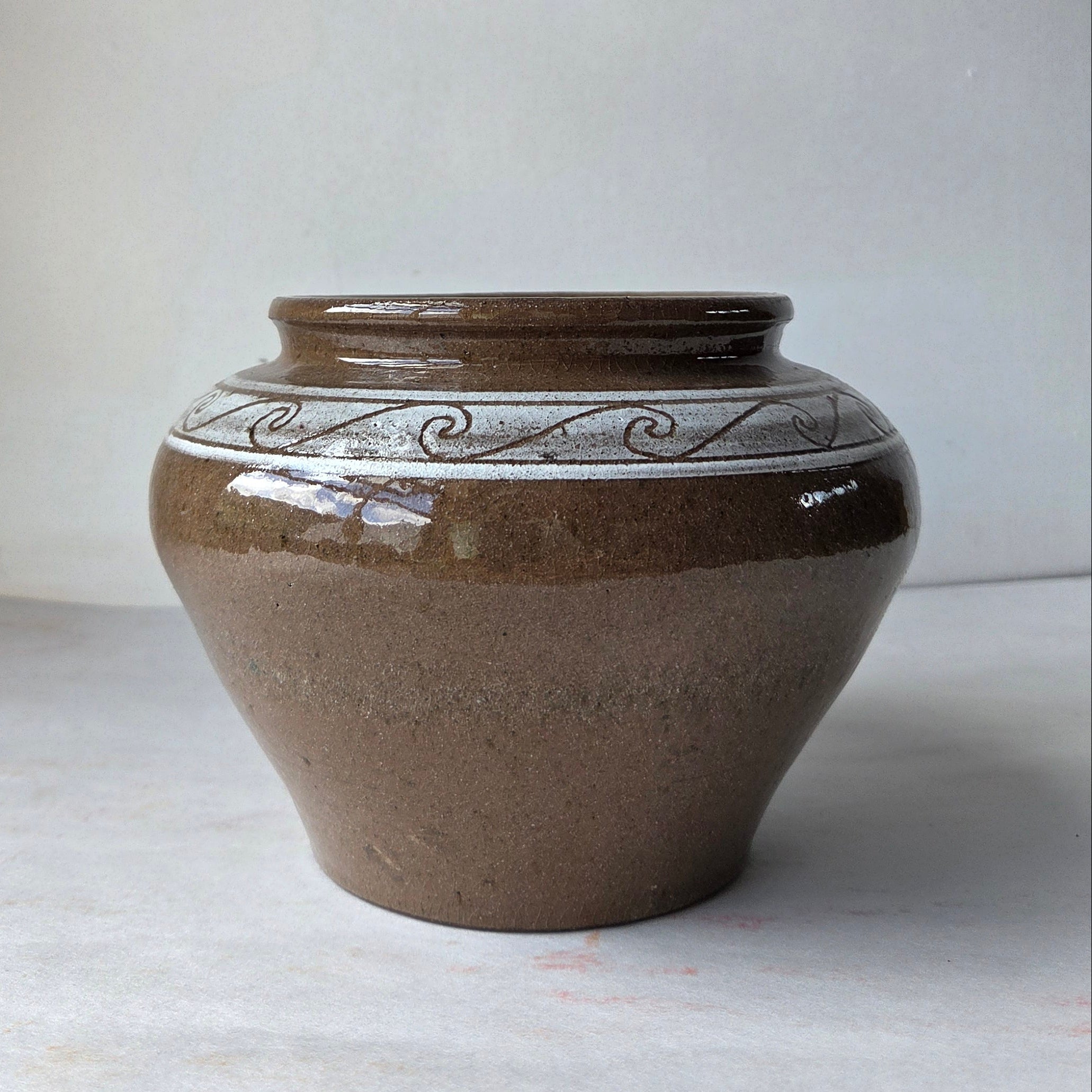 Ceramic vase with decorative patterns on a white background
