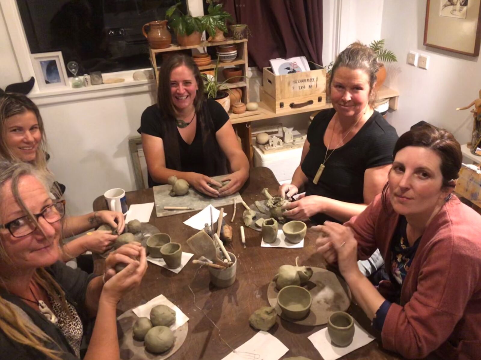 Detailed image of a custom-made clay bowl and sculpture with organic textures